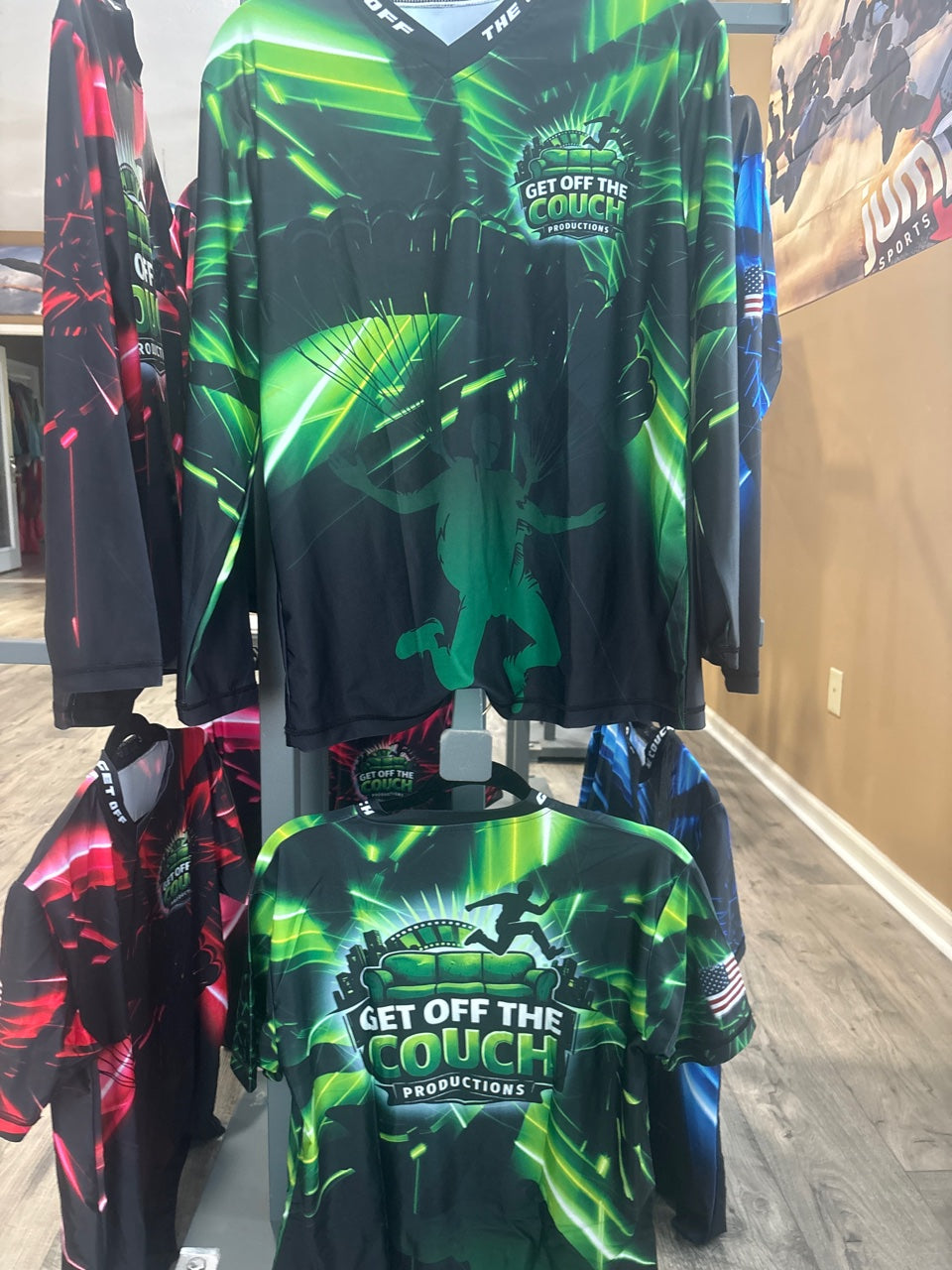 Get Off The Couch Productions shirts in green, red, and blue